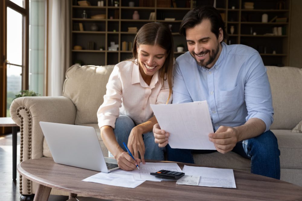 A young couple reviewing paperwork together.