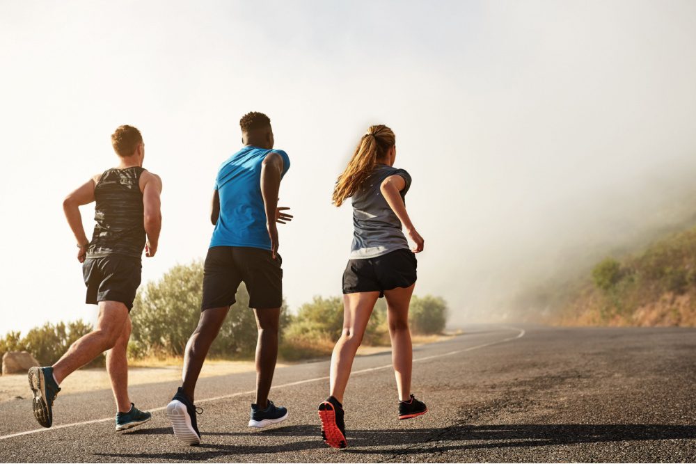 Three people running outdoors.