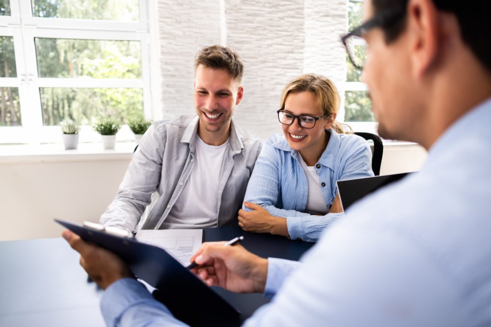 A couple speaking to a mortgage adviser.